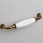 Trinity мебельная ручка-скоба 128 мм старинная латунь с белой керамической вставкой